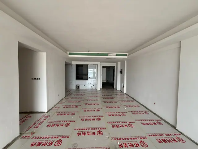 An apartment nearing its finishes in September 2026, floors still under protective covering. Photo: Bayfancy