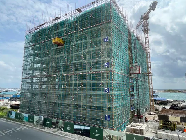 The tower in scaffolding as the 11th-floor slab was completed in July 2025. Photo: Bayfancy